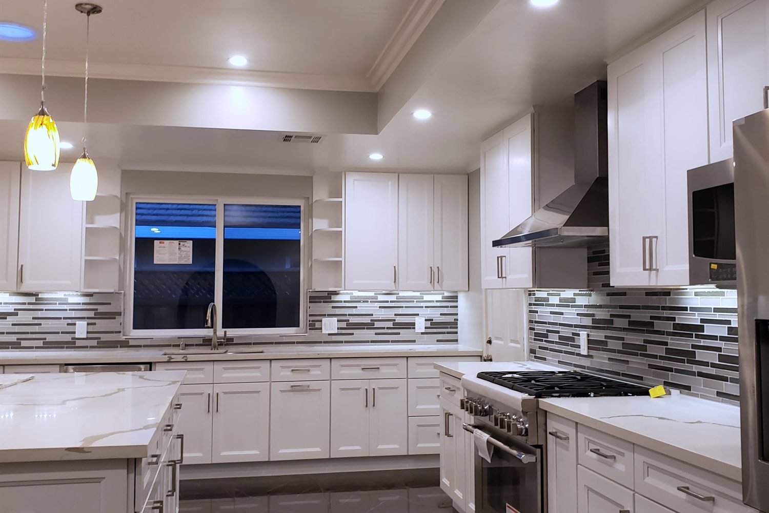 Kitchen after renovation — open plan with quartz island